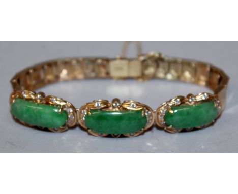 A GOOD HIGH GRADE GOLD, JADE AND DIAMOND BRACELET set with three jade stones surrounded by diamonds.