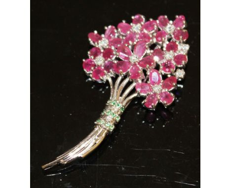 A SILVER RUBY AND EMERALD SET FLOWER BROOCH.