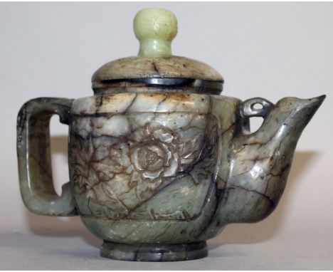 A GOOD EARLY 20TH CENTURY CHINESE JADE TEAPOT & COVER, the sides carved with panels of extended foliage, the stone of predomi
