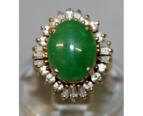 A GOOD GOLD, JADE AND DIAMOND CLUSTER RING with central jade surrounded by diamonds.