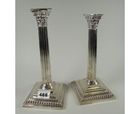 A pair of silver Corinthian column stepped candlestick holders Condition reports provided on request by email for this auctio