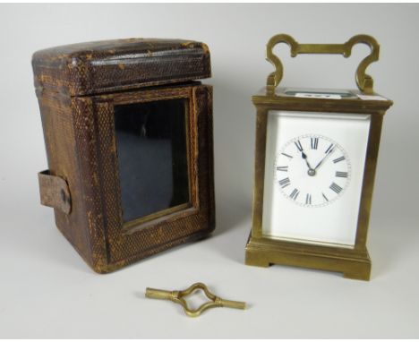 A cased brass carriage clock with rectangular white enamel dial &amp; Roman numerals Condition reports provided on request by
