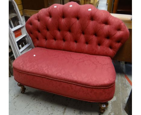 An antique button back fan-shaped settee on turned walnut supports with castors Condition reports provided on request by emai