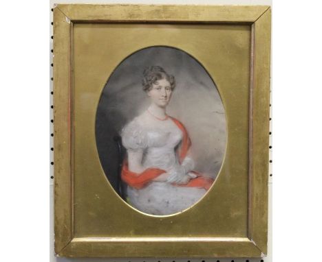 Early 19th century British School, three quarter length portrait of a seated lady wearing a white gown, red bead necklace and