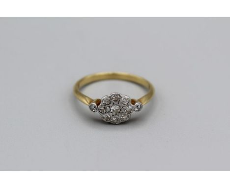 A diamond daisy ring with 11 round eight cut diamonds, unmarked yellow metal tested as 18carat gold