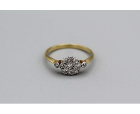 A diamond daisy ring with 11 round eight cut diamonds, unmarked yellow metal tested as 18carat gold