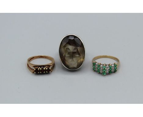 An emerald and diamond cluster ring in 9ct gold, 2.1gm approximately plus a garnet and 9ct gold brutalist ring, 3.3gm approxi