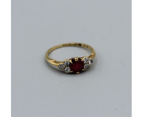 A diamond and ruby ring in 18ct gold, size N 1/2