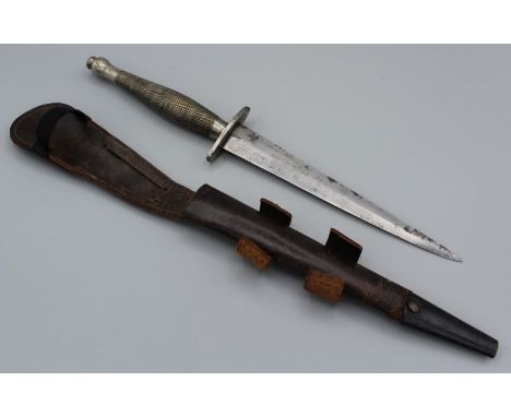 A Fairburn Sykes ' sterile' second pattern fighting knife with milled handle and diamond section double edge blade, with leat