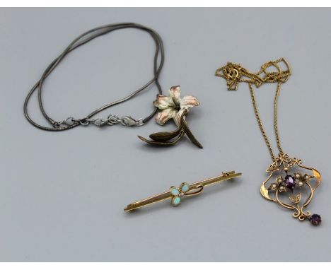 An amethyst and seed pearl pendant, stamped 9carat, with fine curb chain necklace tested as 10 carat gold, a gilt metal flora