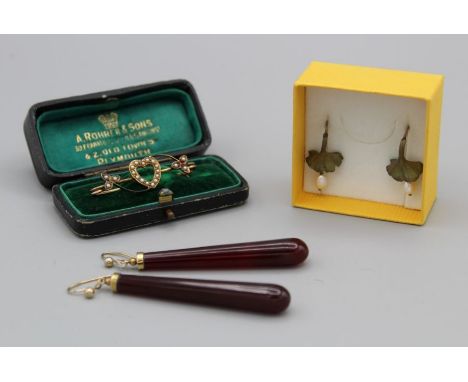 A pair of carnelian drop earrings in unmarked metal setting, a pair of base metal gingko leaf design drop earrings with cultu