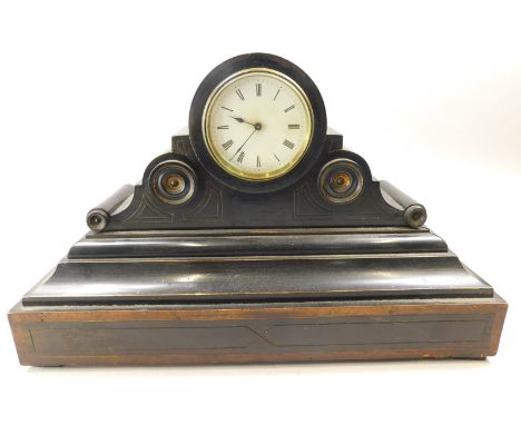 A late 19thC ebonised mantel clock in French style, the enamel dial with Roman numerals, 44cm wide