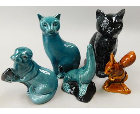 A collection of ceramic animals, to include a cat, an otter and a sealion, with blue glaze, a brown glazed squirrel and a Syl