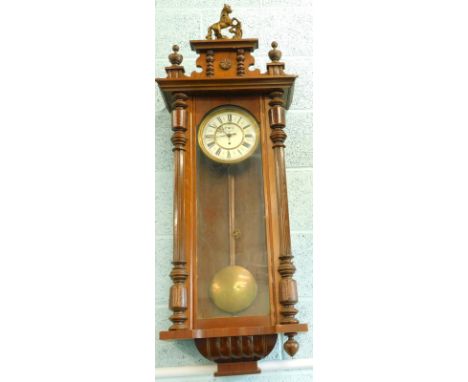 A late 19thC Gustav Becker Vienna wall clock, in walnut case, the enamel dial with Roman numerals and stamped GB, 126cm high