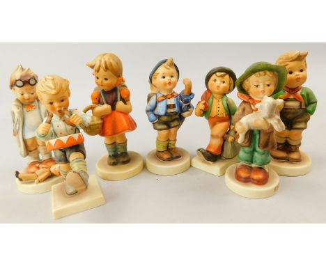 A collection of seven Goebel Hummel figures, to include a boy with a small doll, a drummer, child with lamb etc.