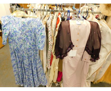 Various vintage ladies' clothing, to include a Jaeger coral coloured wiggle dress, further day dresses, skirts etc. (one rail