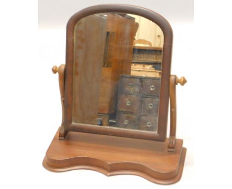 A mahogany dressing table mirror in George III style, with shield shaped mirror plate, the box base with two drawers on ogee 