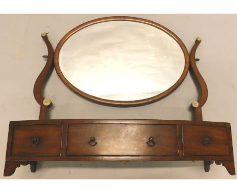 A 19thC mahogany dressing table mirror, the oval plate on shaped supports, the bow fronted base with three frieze drawers, on