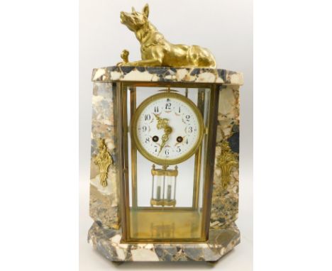 A French Art Deco style variegated marble mantel clock, the case mounted with a gilt metal Alsatian type dog, the dial with A