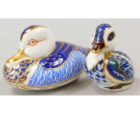 Two Royal Crown Derby porcelain paperweights, a duck with gold button and a duckling with gold button