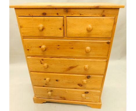 A late 20thC/ 21stC pine chest of two short and three long drawers, each with turned wood handles on bracket feet, 91cm wide