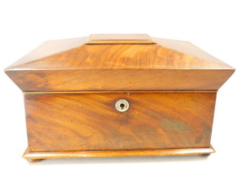A Victorian mahogany sarcophagus shaped tea caddy, with a hinged lid, enclosing a two further caddys and a vacant recess, VR 