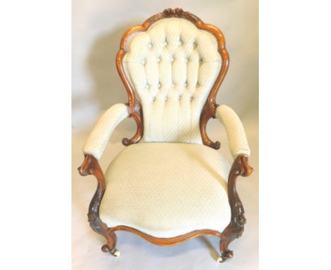 A Victorian walnut showframe open armchair, with padded button back, padded arm rests and seat, upholstered in grey fabric, t