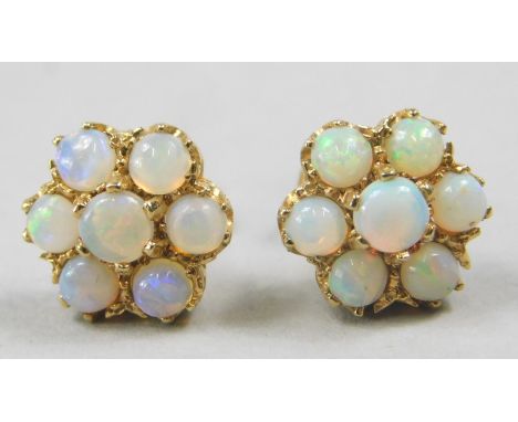 A pair of opal cluster earrings, each set with seven opals, in a claw setting, yellow metal, marked 18ct, 2.8g all in. 
