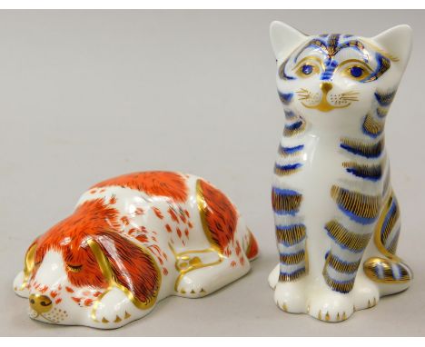 Two Royal Crown Derby porcelain paperweights, a tabby cat and a seated spaniel, gold button