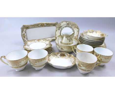 A Noritake porcelain part tea service, decorated with gold borders, printed mark in green to underside