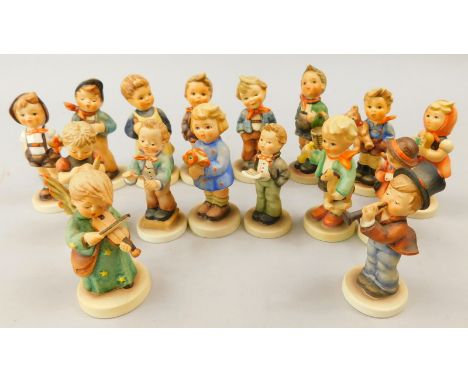 A collection of Goebel Hummel small figures, to include child playing a violin, boy with a teddy bear, a basket playing a hor