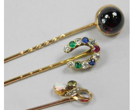 Three stick pins, to include a 9ct gold example set with seed pearl, peridot and opal, a 9ct horseshoe pin, set with diamond,