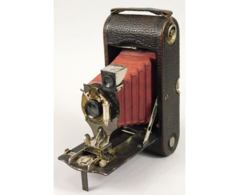 An early 20thC Kodak Antique 1910 folding camera, TB2550100 with Bausch and Lomb lens, with simulated leather decoration