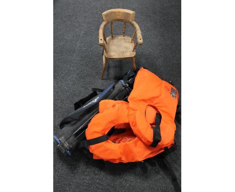 Two wooden child's chairs, three life jackets, a bag of golf clubs and a hockey stick 