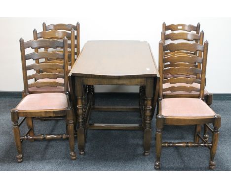 A Reprodux oak gate leg table and six ladder back dining chairs. 