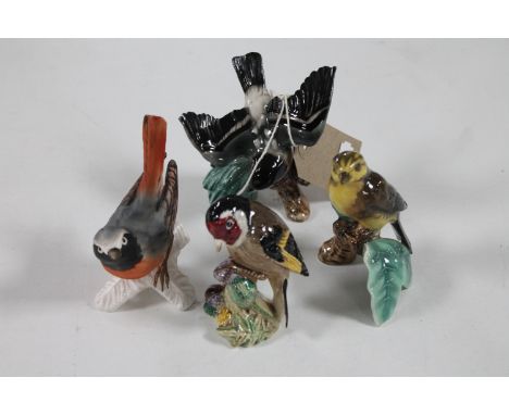 A Beswick bird figure and three Goebel bird figures 