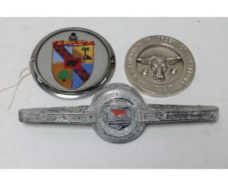 A vintage car badge marked 64 medium Regt R.A, a Morris Cooper car badge and a Royal Antediluvian Order of Buffaloes car badg