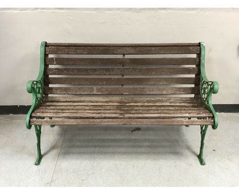 A cast iron and wooden slatted garden bench 