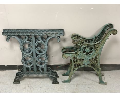 A pair of cast iron bench ends and a pair of cast iron table bases 