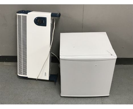 A bench top fridge and a Dimplex electric panel heater 