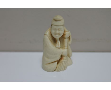 A resin netsuke - elderly gentleman with brush 