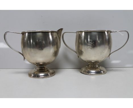 A white metal sugar basin and milk jug, marked 'Sterling'