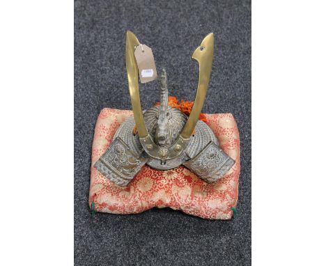 A Japanese brass samurai presentation helmet on cushion, presented from Yokkaichi Port Authority, June 3, 1976 