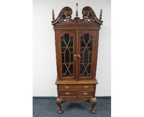 A reproduction Chippendale style display cabinet on claw and ball feet 