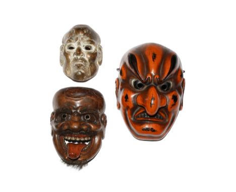 THREE JAPANESE LACQUERED MASKS MEIJI PERIOD, 19TH AND 20TH CENTURY The largest in red and black lacquer, carved as a grimacin