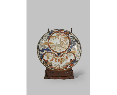 A MASSIVE JAPANESE IMARI CHARGER MEIJI PERIOD, 19TH CENTURY Decorated in underglaze blue, iron-red and gilt with two large sh