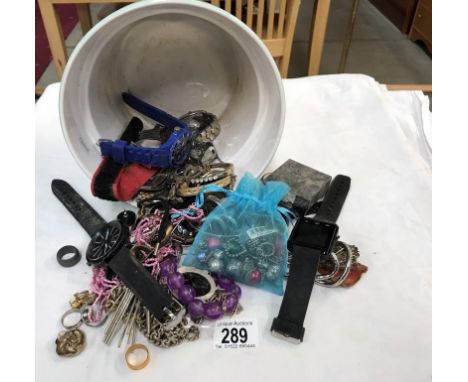 A mixed lot of costume jewellery and watches in a planter