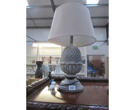 A table lamp in the shape of a pine cone complete with shade