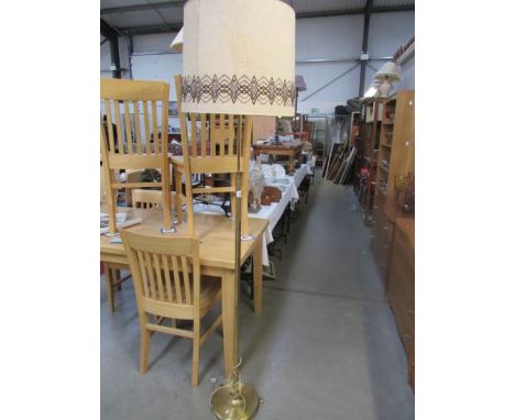 A metal standard lamp with shade