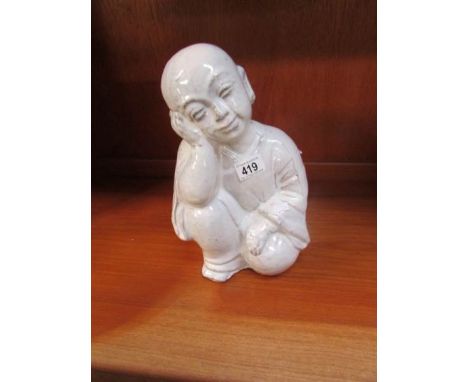 A ceramic figure of a Chinese boy
